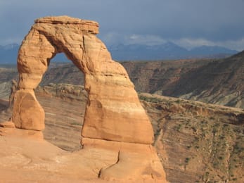 Delicate Arch in the evening light, in front of the La Sal Mountains.