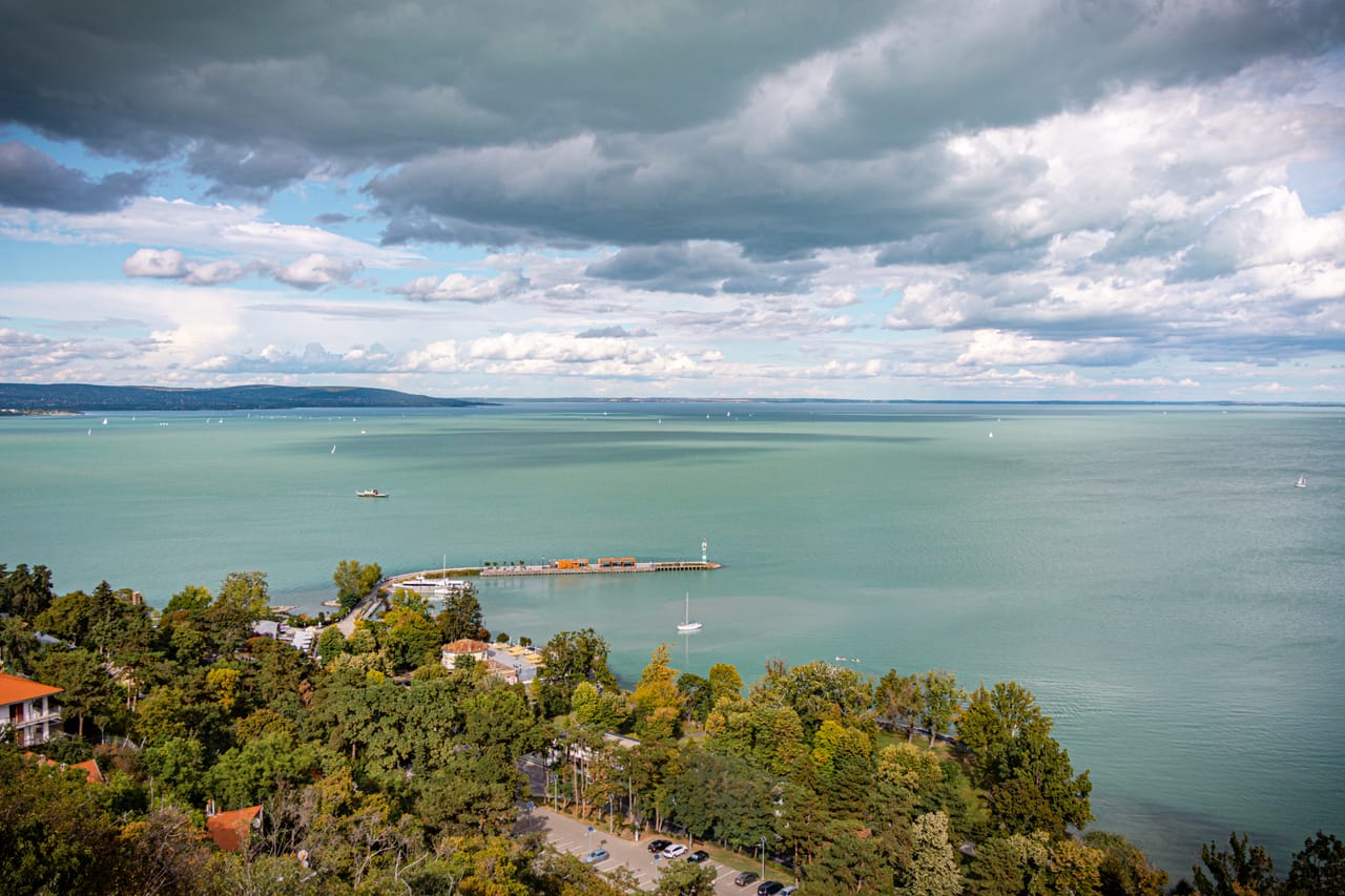 Le Balaton turquoise vu des hauteurs de Tihany, sous un ciel de nuages.