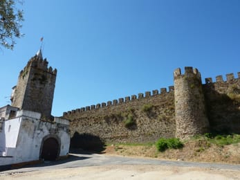 La porte blanchie à la chaux et les remparts du château de Montemor-o-Novo.