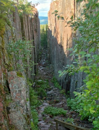 Slåttdalsskrevan, le couloir entre deux parois de granite rouge. Le passage au fond est fermé depuis juin 2023 ; on la voit aujourd’hui d’en haut.