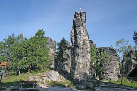 Une tour de grès des Tiské stěny au-dessus des bouleaux et des mélèzes.