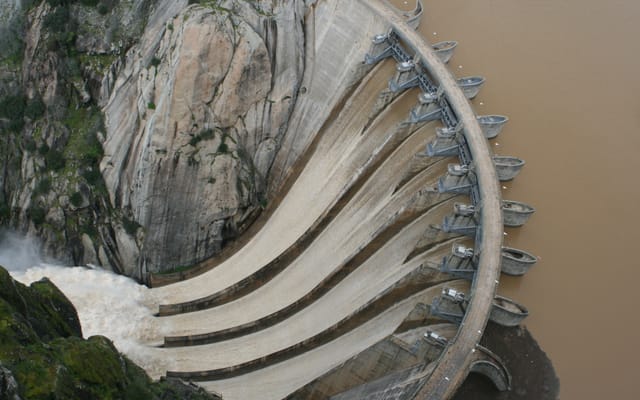 The Aldeadávila dam holds the river back where the canyon runs deepest — two hundred metres of granite on either side.